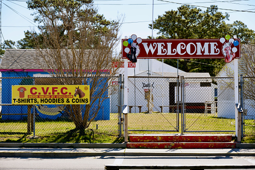 Chincoteague Island, Virginia, USA - March 21, 2024: A locked gate at the main entrance to the Chincoteague Carnival Grounds where the famous Chincoteague Ponies are auctioned off each summer by the Chincoteague Volunteer Fire Company.