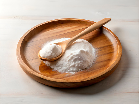 baking soda in a wooden plate with a spoon