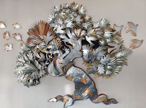 3D Craft and sculpture of trees, leaves, trunk, and flying birds mounted on a wall, made of forged metal steel, brass, and copper plates by Indonesian artist.