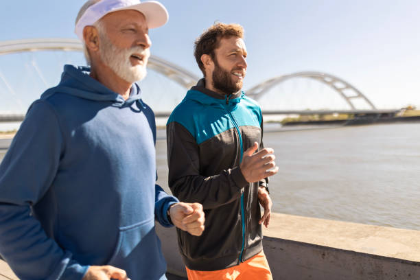 istock Father and Son Bonding While Running Along the River 2123042579