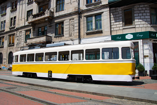 Scheveningen, The Netherlands - June 17, 2014: A tram of HTM (HTM Personenvervoer NV) in the city center of Scheveningen, The Netherlands. Some pedestrians in the background. HTM Personenvervoer NV is a public transport company in the Netherlands operating trams, lightrail and buses in various cities and regios
