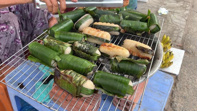 Vietnamese New Year cut pie with peas, rice and meat hands is wrapping Chung cake, the Vietnamese traditional food made with pork, mung bean, sticky rice, wrapped in green leaves and then boiled.