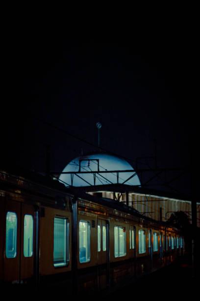 A tram rushes past on a foggy Warsaw night, leaving streaks of light in its wake. The long exposure captures the motion, blending urban energy with the eerie stillness of the misty atmosphere.
