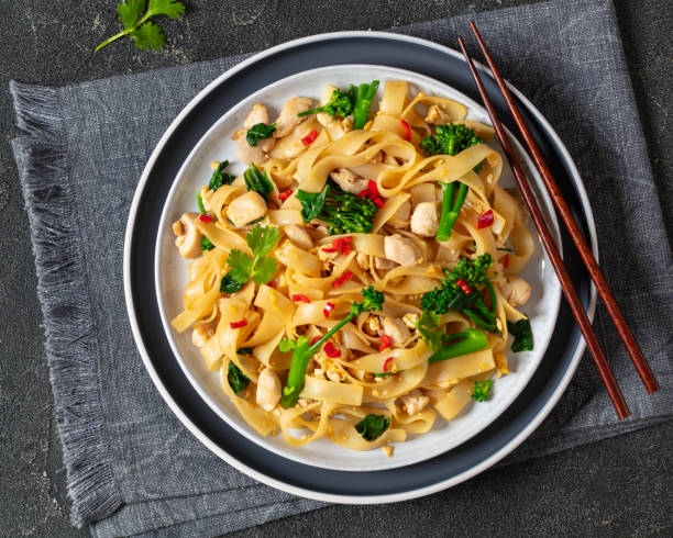 istock rice noodles with chicken, eggs, chinese broccoli 2123042988