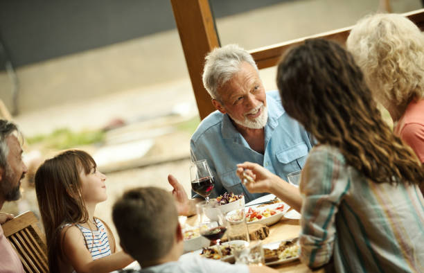 istock Family having dinner at a weekend house. 2123043240