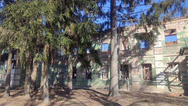istock old ruined building behind a fence 2123043401