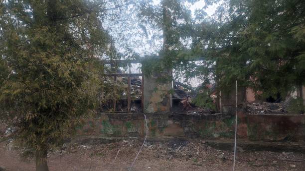 istock old ruined building behind a fence 2123047080
