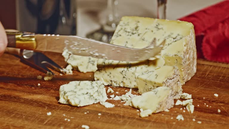 Cutting a slice of blue cheese