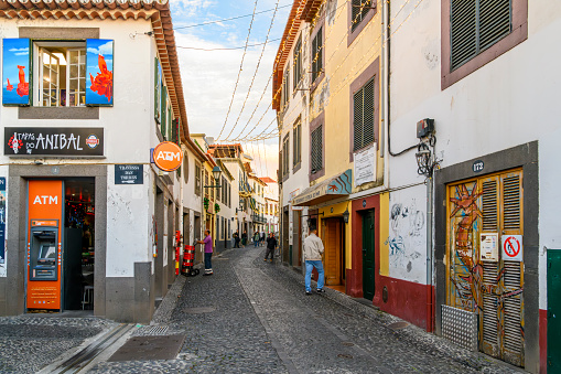 The famous Rua de Santa Maria narrow street of cafes, colorful doors and shops in the historic medieval old town of Funchal, Madeira Portugal.