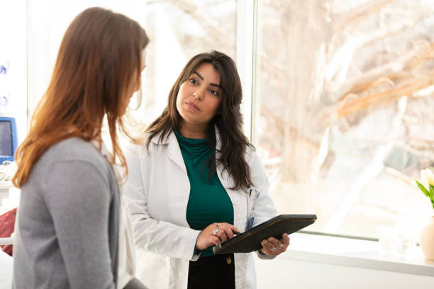 istock Female doctor uses tablet to update patient's record 2123088962