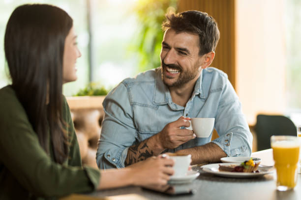 istock Cheerful man laughing with his girlfriend in restaurant. 2123091521