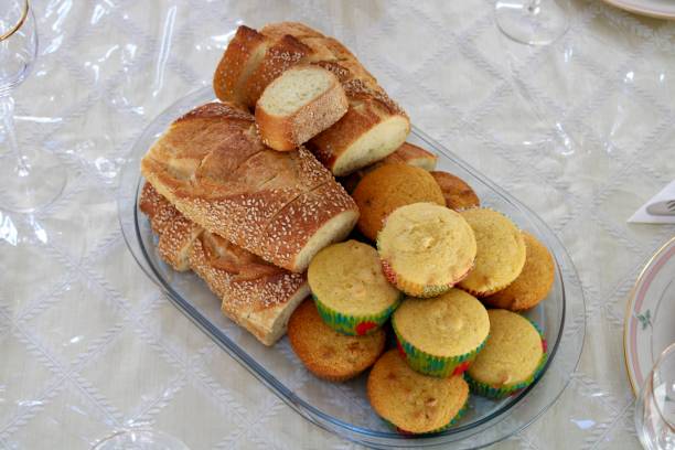 Bread Basket A bread tray fill with Italian bread and corn muffins. bread bun corn bread basket stock pictures, royalty-free photos & images