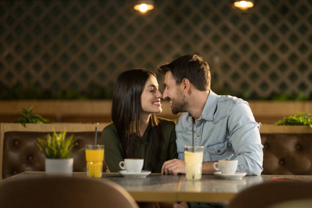 istock Young couple falling in love on their date in a cafe. 2123098409