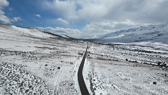 Desolate snowy road in empty landscape