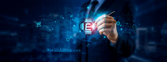 E-commerce concept. Businessman pointing at E-commerce icon and data for global online network on a graphic interface. Digital, retail, and payment transactions in a seamless, global market.