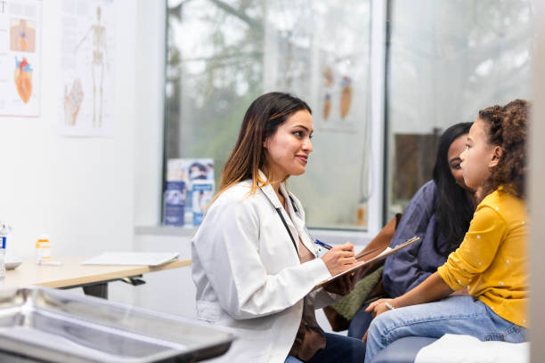 istock Young female patient talks to her doctor about her symptoms 2123106387
