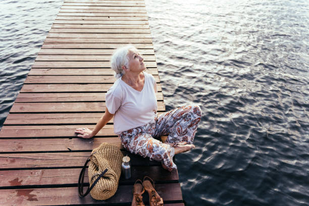 Senior aged woman feeling freedom,enjoying vacation. No stress,calm mind,relax, happy retirement, healthy lifestyle, outdoor portrait. Summer nature. Silence. Senior aged woman feeling freedom,enjoying vacation. No stress,calm mind,relax, happy retirement, healthy lifestyle, outdoor portrait. walking beach women sadness stock pictures, royalty-free photos & images