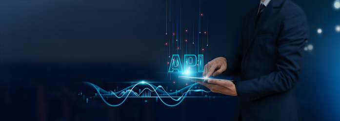 API: Integration Concept, Businessman Uses Tablet on Expansive Global Networking, Data Exchange, Collaboration, Innovation, Developing Smart Solutions from Digital Technology.