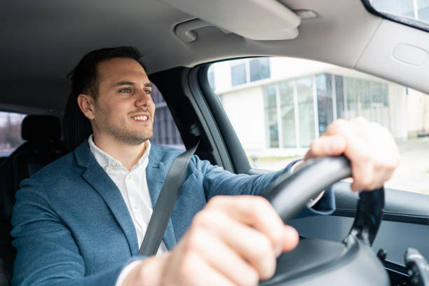 istock Young Caucasian businessman driving the car 2123155183