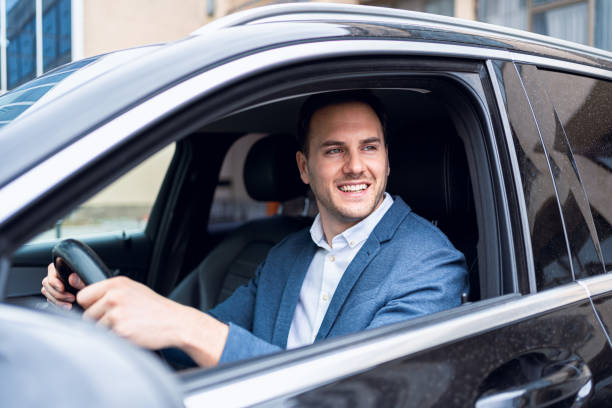 istock Young Caucasian businessman driving the car 2123155192