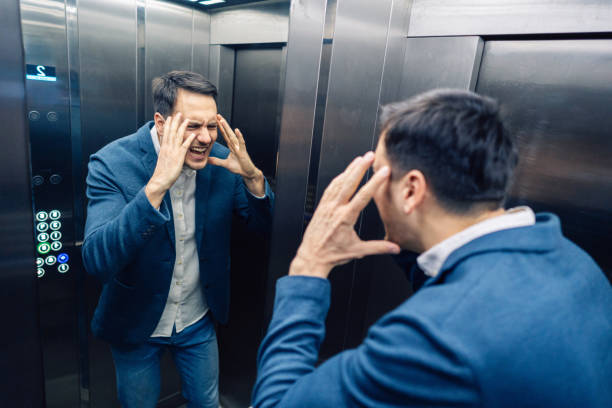 istock Angry overworked Caucasian businessman having an mental burnout in the elevator 2123155193