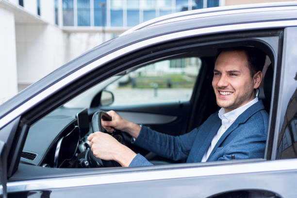 istock Young Caucasian businessman driving the car 2123155195