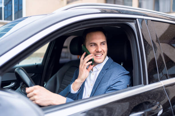 istock Irresponsible young Caucasian businessman, talking on mobile phone, while driving the car 2123155198