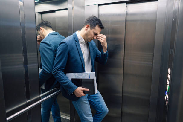 istock Tired Caucasian businessman in the elevator 2123155209