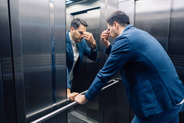 istock Overworked Caucasian businessman having an mental burnout in the elevator 2123155211