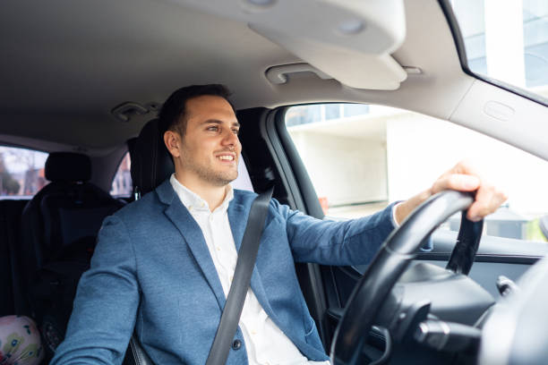 istock Young Caucasian businessman driving the car 2123155245