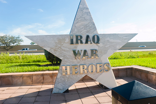 Memorial at the Veterans Parkway SE 24th Street, Cape Coral, Florida, USA - October 14th, 2023: Memorial stone in the shape of a star for fallen US soldiers during the Iraq War, close to the Four Mile Cove Ecological Preserve in Cape Coral. Cape Coral, Florida, USA.