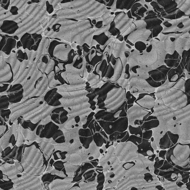 Close up of antique 19th century black and grey paper marbling texture full frame.