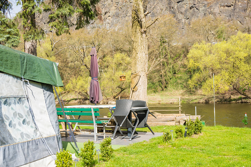 Camping Motorhomes. Near the campsite on the island of Zadn Treban in the Czech Republic. Recreational Vehicles Selling. Caravaning Industry. camping on the beach in mountains High quality photo
