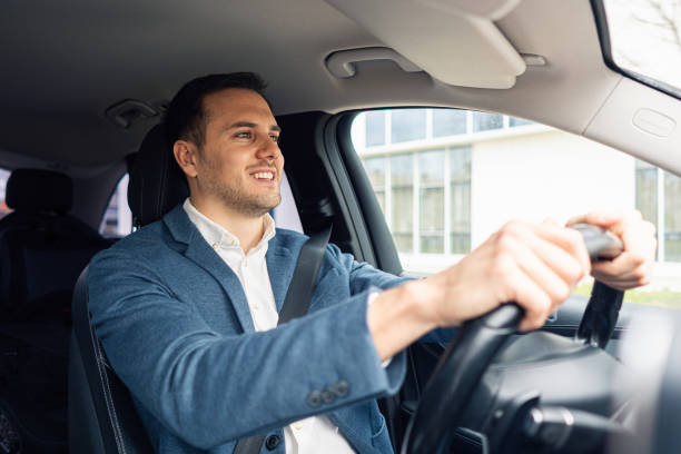 istock Young Caucasian businessman driving the car 2123249312
