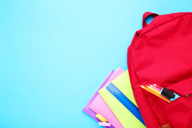 istock Backpack with school supplies on blue background 2123262258