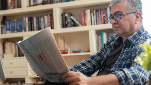 businessman reading newspaper at office