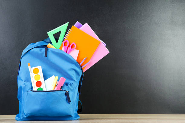 istock Backpack with school supplies on black background 2123266937