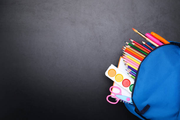 istock Backpack with school supplies on black background 2123274178