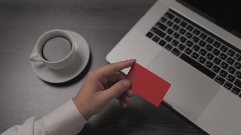 Close-up of male hand typing at laptop, Young man pressed the credit card code to pay online via the computer at the desk in the room, Online purchases of credit cards. Businessman working freelance