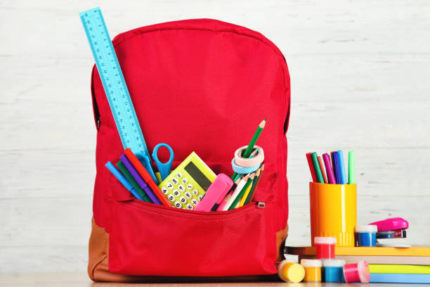 istock Backpack with school supplies on white wooden background 2123280937