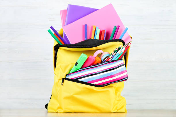 istock Backpack with school supplies on white wooden background 2123284533