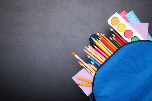 istock Backpack with school supplies on black background 2123287598
