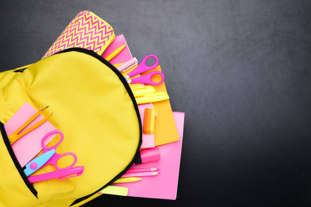 istock Backpack with school supplies on black background 2123288117