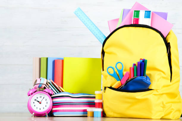 istock Backpack with school supplies on white wooden background 2123288635