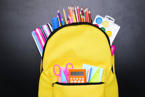istock Backpack with school supplies on black background 2123291716