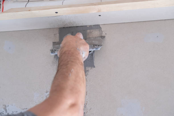 istock Applying decorative putty. White abstract texture of surface covered with putty 2123315076