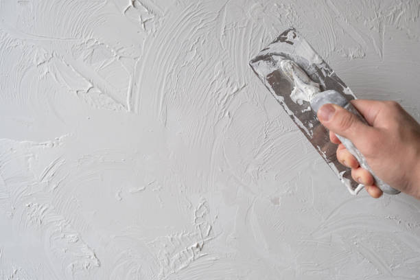 istock Applying decorative putty. White abstract texture of surface covered with putty 2123316535