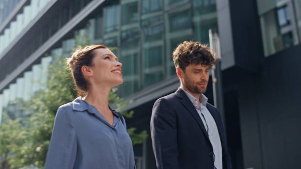 istock Business managers going outside together closeup. Smiling partners communicating 2123332687