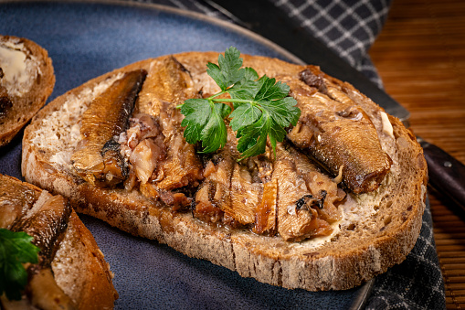 Slices of multigrain bread with sprats.