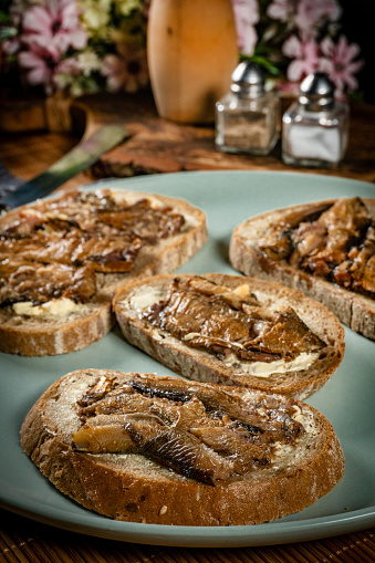 Slices of multigrain bread with sprats.